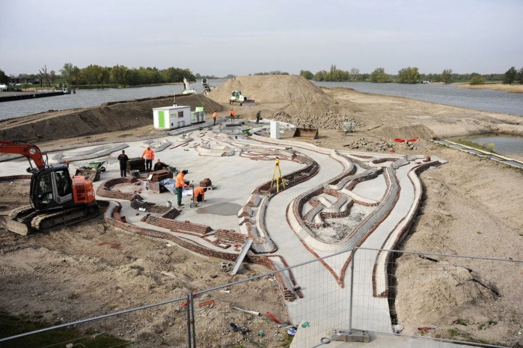 Water-speelplein in de publieke buitenruimte van het Biesbosch MuseumEiland, met stromend water en betonnen structuren